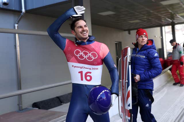 Great Britain’s Dom Parsons, en route to a dramatic men's skeleton bronze medal, waves to supporters 