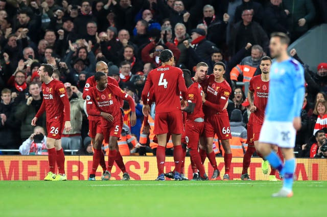 Sadio Mane, centre right, celebrates scoring Liverpool's third goal against City at Anfield