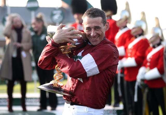 Davy Russell hugs the Grand National trophy