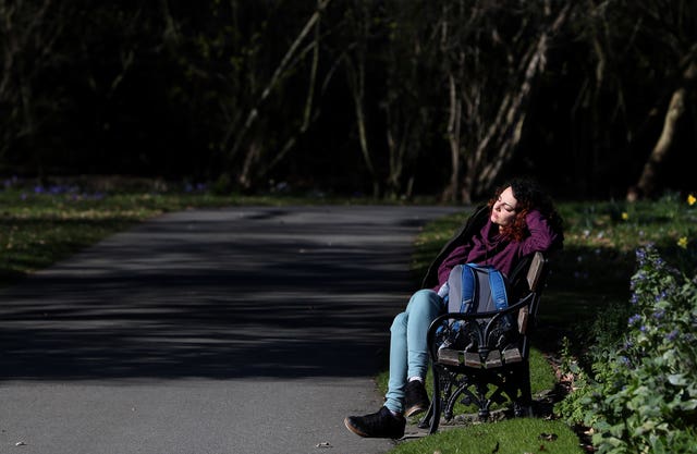A woman enjoys the sunshine in the Botanic Gardens in Dublin