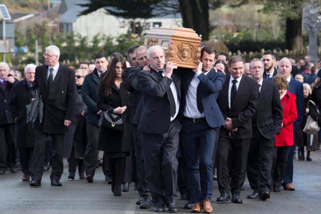 Liam Miller's coffin is carried following the funeral service at St John the Baptist Church in Ovens, County Cork