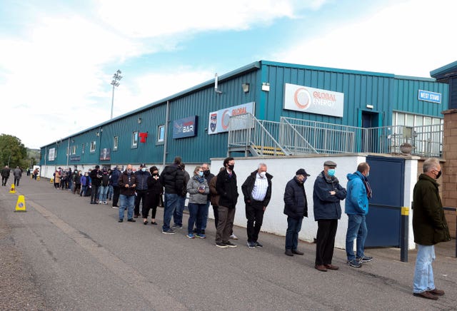 Ross County fans form a socially distanced queue