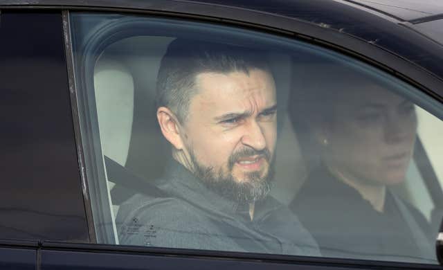 Band member Mike Hogan and his wife Siobhan arrive for the funeral (Niall Carson/PA)