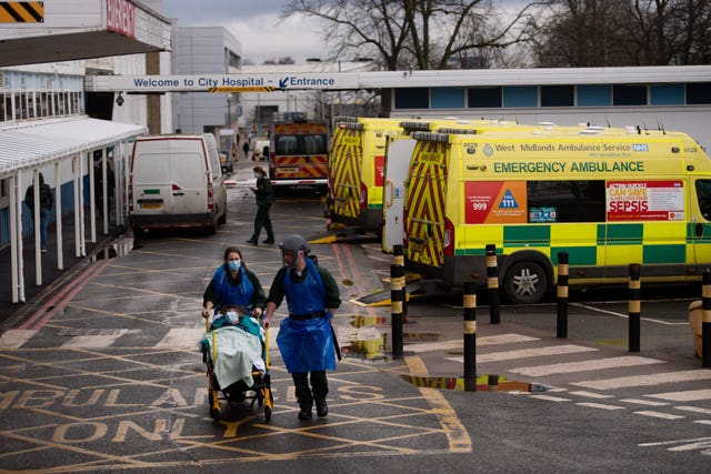 Ambulance crews transport patients into City Hospital in Birmingham (Jacob King/PA)