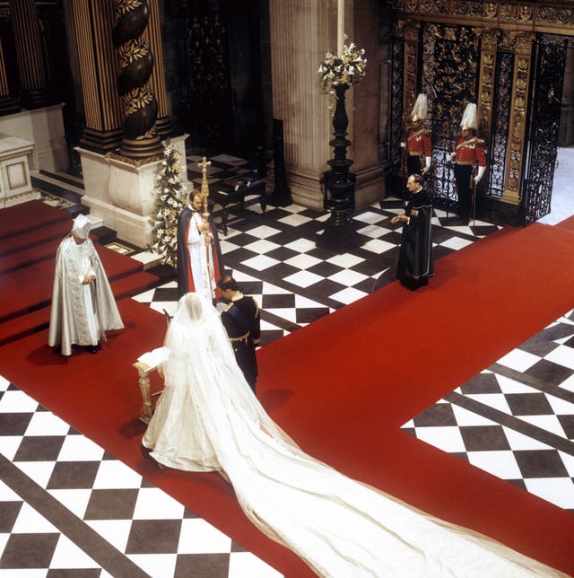 The Prince and Princess of Wales at the High Altar in front of the Archbishop of Canterbury, Robert Runcie, during their wedding at St Paul's Cathedral