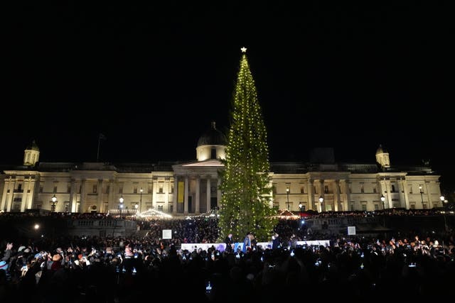 People attend the Christmas lights switch-on event at Trafalgar Square in London