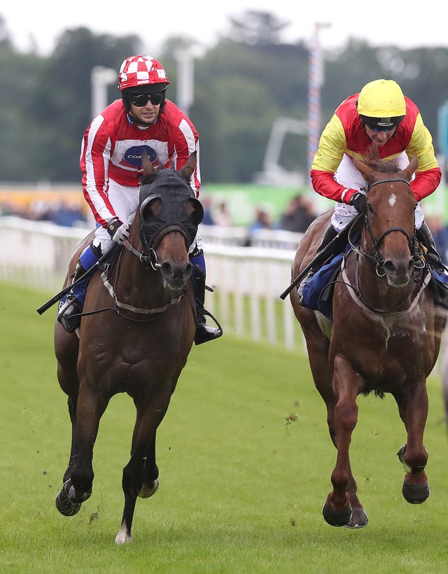 Chris Hughes, left, rides Carnageo during the race