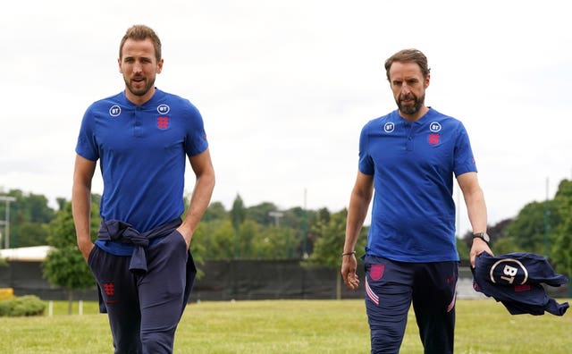 Harry Kane, left, walks with manager Gareth Southgate before a press conference