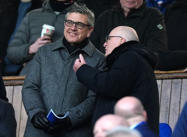Andrew Cavenagh smiles as he talks to someone in the Ibrox director's box
