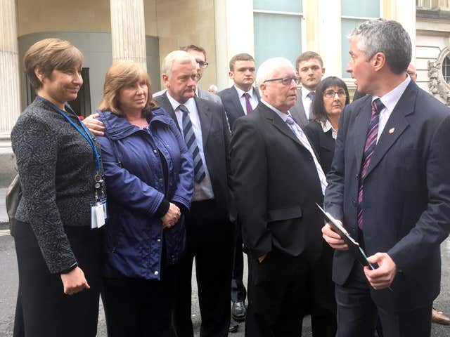 The families of Laura Mortimer and Ella Dalby outside Bristol Crown Court with DC Lennox Shaw of Gloucestershire Police (Claire Hayhurst/PA)