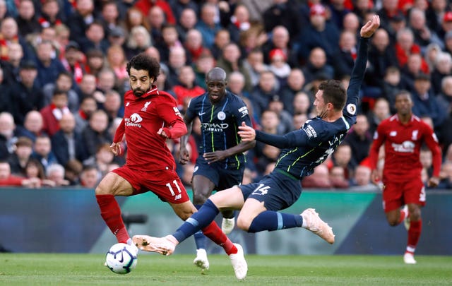 Manchester City’s Aymeric Laporte tackles Liverpool's Mohamed Salah