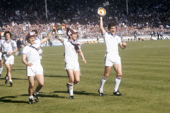 Paul Allen and Geoff Pike celebrate with the FA Cup as team-mate Ray Stewart makes do with the trophy lid