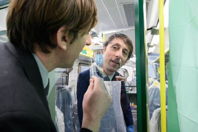 A team leader carrying out a swab test