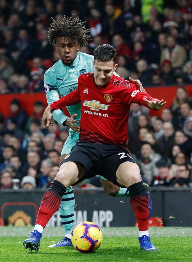 Dalot shields the ball from Arsenal's Alex Iwobi (Martin Rickett/PA).