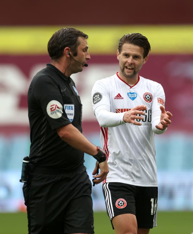 Michael Oliver, left, discusses the goal-line incident with Sheffield United's Oliver Norwood 