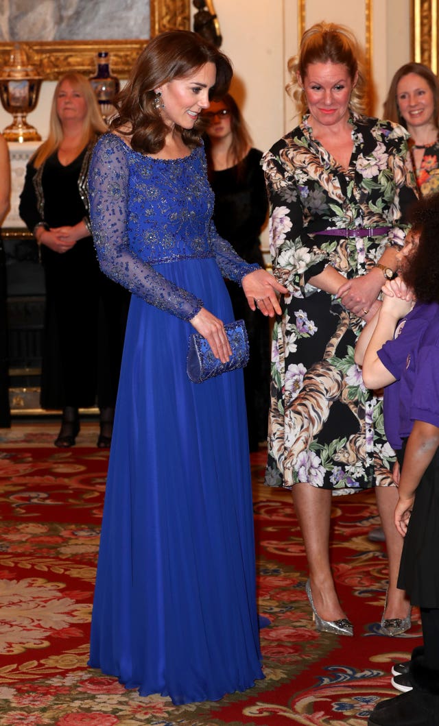 The Duchess of Cambridge speaks to members of a school choir as she hosts a gala dinner at Buckingham Palace