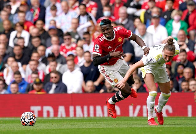 Pogba (left) registered four assists in the 5-1 against Leeds last August (Martin Rickett/PA).