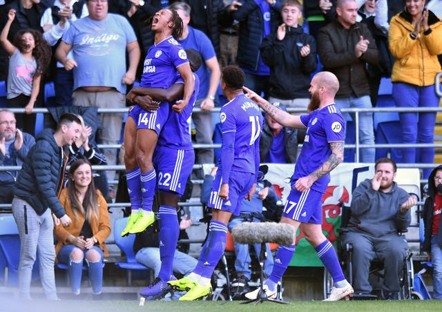 Cardiff’s Bobby Reid, left, is held aloft after scoring in the 4-2 victory over Fulham