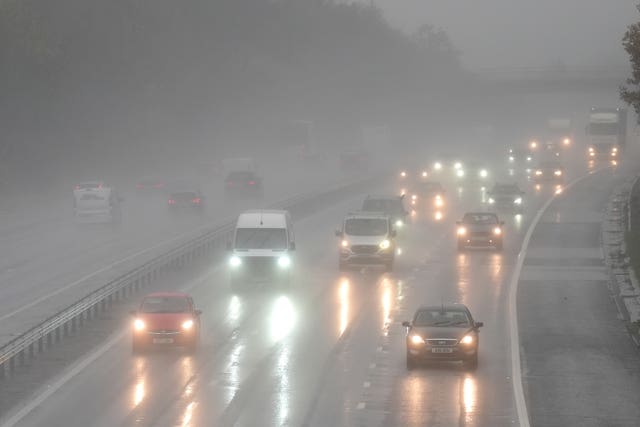 Motorists drive through the rain on the M11 near Harlow in Essex