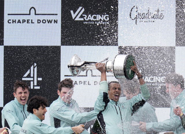 Noam Mouelle, centre right, lifts the trophy as he celebrates with crewmates after Cambridge’s Boat Race win