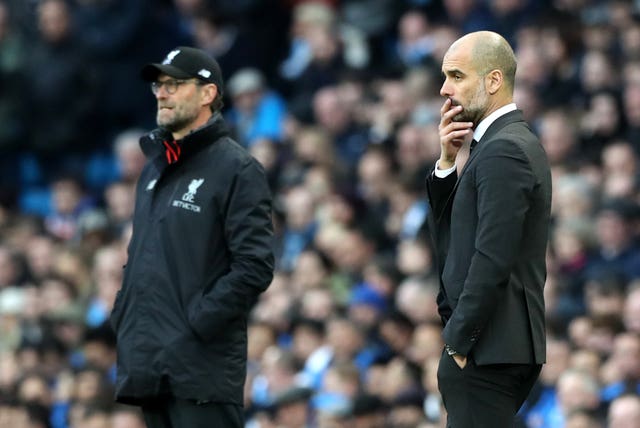 Klopp (left) and Manchester City manager Pep Guardiola are embroiled in a title race