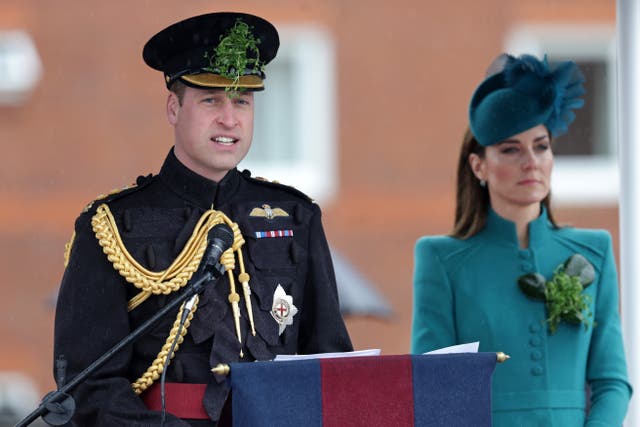The Prince of Wales speaks on stage with the Princess of Wales during a visit to the 1st Battalion Irish Guards for the St Patrick’s Day Parade, at Mons Barracks in Aldershot