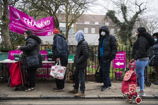 People queue at the Ringcross Foodbank, in north London