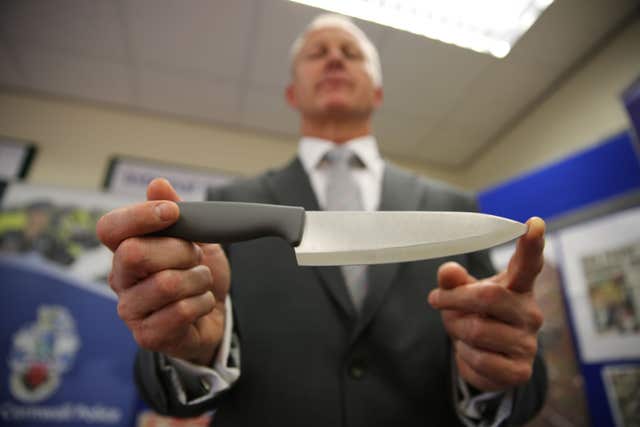 Retired Detective Superintendent Paul Burgan holds a kitchen knife which is believed to be similar to the weapon used to murder Kate Bushell in 1997 (Devon and Cornwall Police/PA).