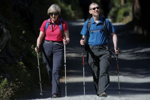 Theresa May has given details of how she likes to unwind, including walking holidays with husband Philip (Marco Bertorello/PA)