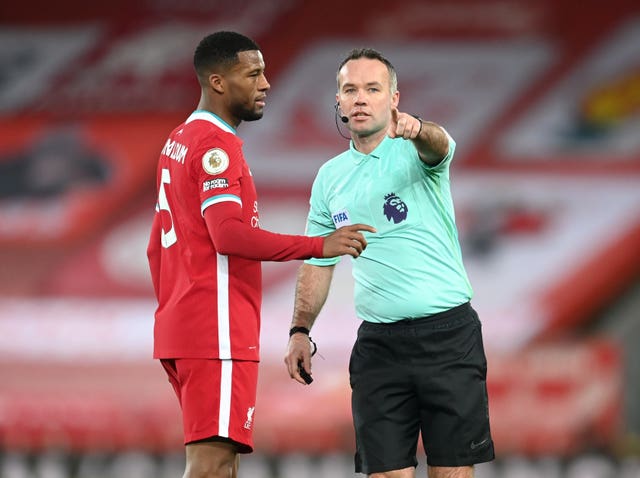 Liverpool midfielder Georginio Wijnaldum with referee Paul Tierney