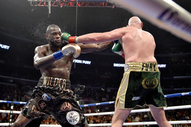 Wilder and Fury drew around 325,000 PPV buys for their first fight (Lionel Hahn/PA)