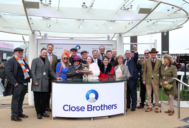 Connections of Marie’s Rock celebrate after winning the Close Brothers Mares’ Hurdle