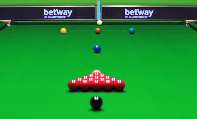 The golden ball will be placed on the cushion in line with the brown