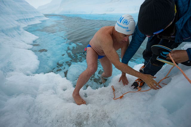 Pugh became the first person to swim under an Antarctic ice sheet – wearing just a pair of trunks, cap and googles (Lewis Pugh/PA)