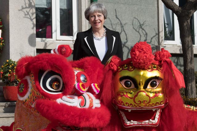 Prime Minister Theresa May ‘dots the eye’ of a Chinese dragon in Beijing