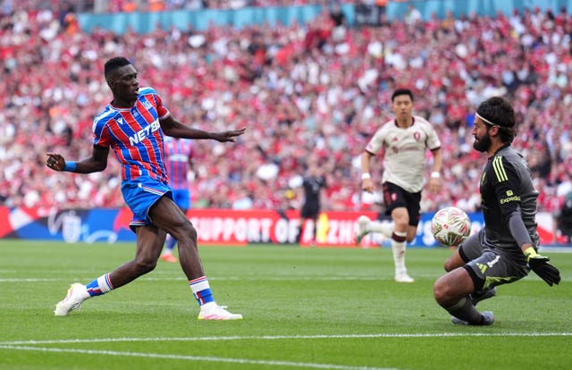 Crystal Palace’s Ismaila Sarr (left) scores their side’s second goal of the game past Liverpool goalkeeper Alisson Becker during the FA Community Shield match at Wembley Stadium,