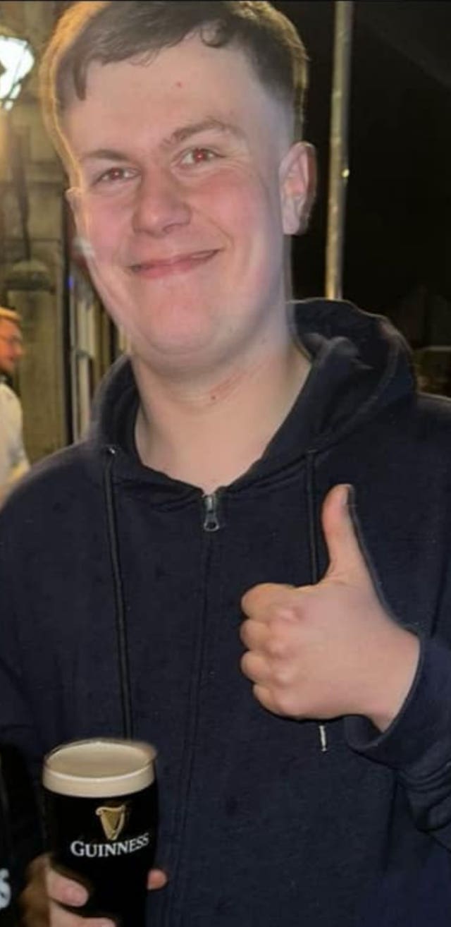 Handout photo of Louie Thorn smiling while giving the thumbs-up and holding a drink