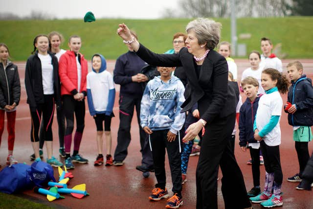 Prime Minister Theresa May throws a bean bag (Christopher Furlong/PA)