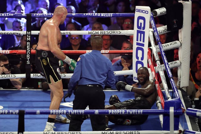 Tyson Fury (left) knocks down Deontay Wilder