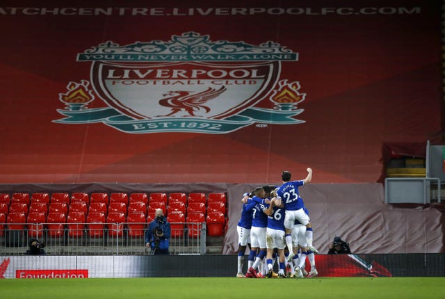 Everton players celebrate on their way to victory in the Merseyside derby