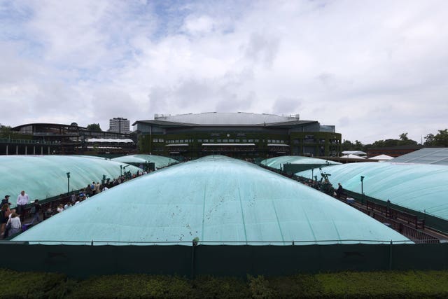 Court 10 and the outside courts are covered as rain stops play on day six of Wimbledon