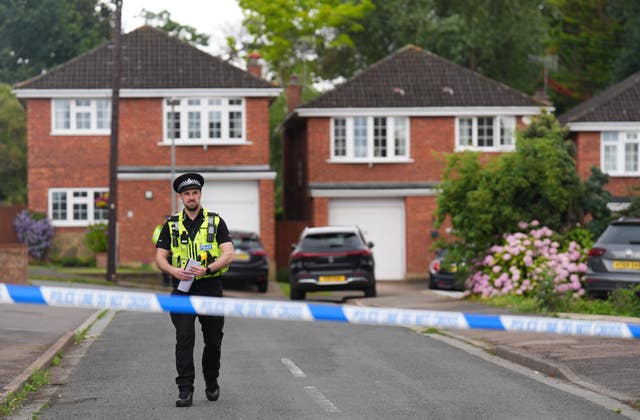 Police man in road that is taped off by police tape