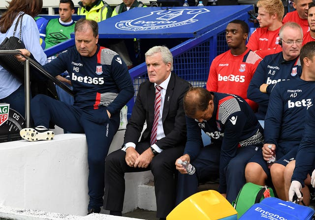 Mark Hughes, centre, shows his displeasure during Stoke's defeat at Everton last August