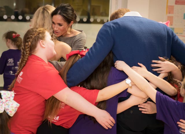 Prince Harry and Meghan Markle meet children during a visit to Star Hub in Tremorfa (Geoff Pugh/The Daily Telegraph/PA)