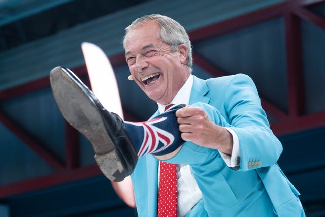 Nigel Farage showing off his Union flag socks that he's wearing