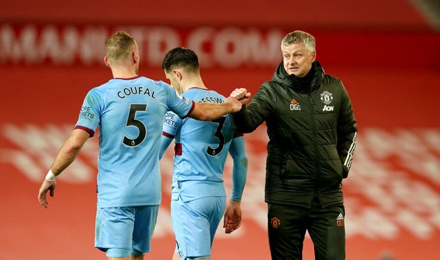 Ole Gunnar Solskjaer, right, bumps fists with West Ham’s Vladimir Coufal after the game