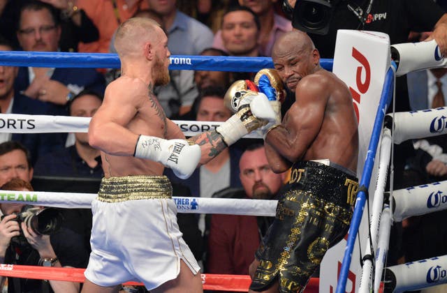 Conor McGregor, left, had a brief foray into boxing during his UFC hiatus (PA)