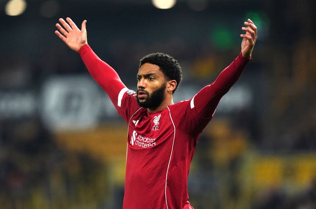 Liverpool defender Joe Gomez raises both arms