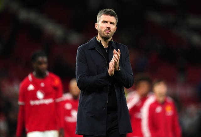 Michael Carrick applauds the fans