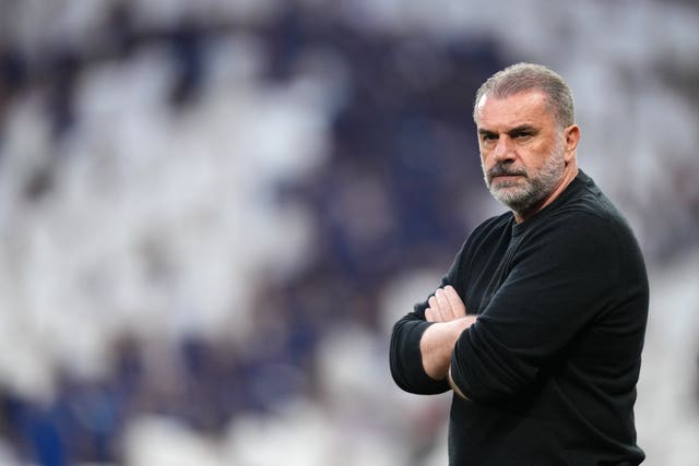 Tottenham manager Ange Postecoglou stands with his arms folded